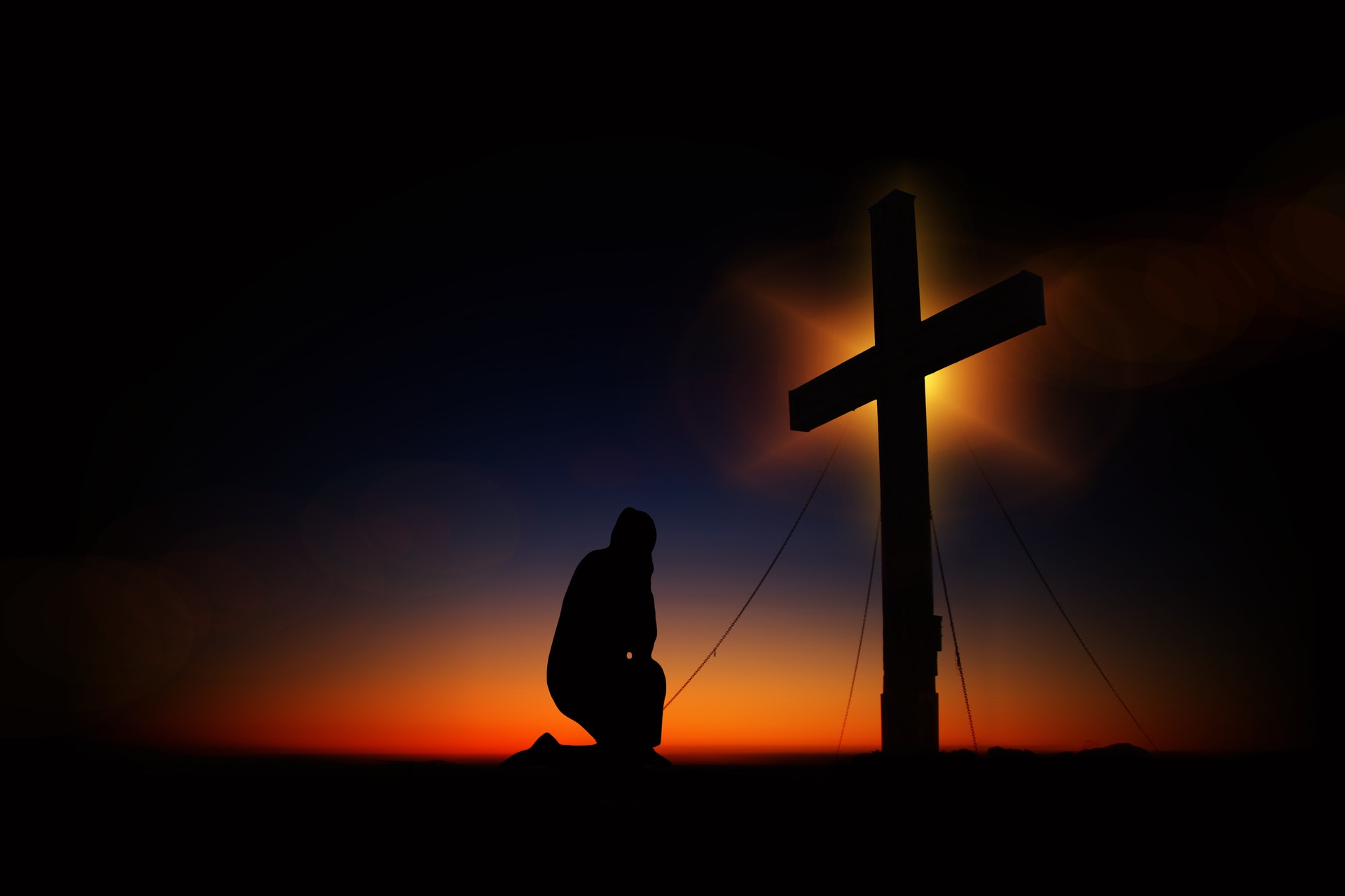 kneeling in prayer at cross with prayer music and meditation